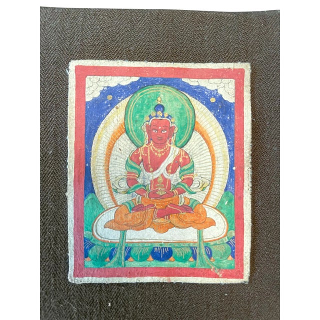 A trio of paintings depicting Buddhas and a deity from the late 19th and early 20th centuries. Distemper on canvas mounted...