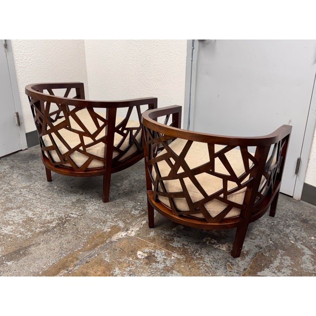 Design Plus Gallery presents a Pair of Ankara Lounge Chairs by Crate & Barrel. Each chair has a curved tub-style wood...