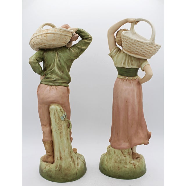 Pair of Royal Dux, Bohemia, Porcelain Figures, 1912-1918. Peasant carrying harvest baskets, model #1830 & 1831....