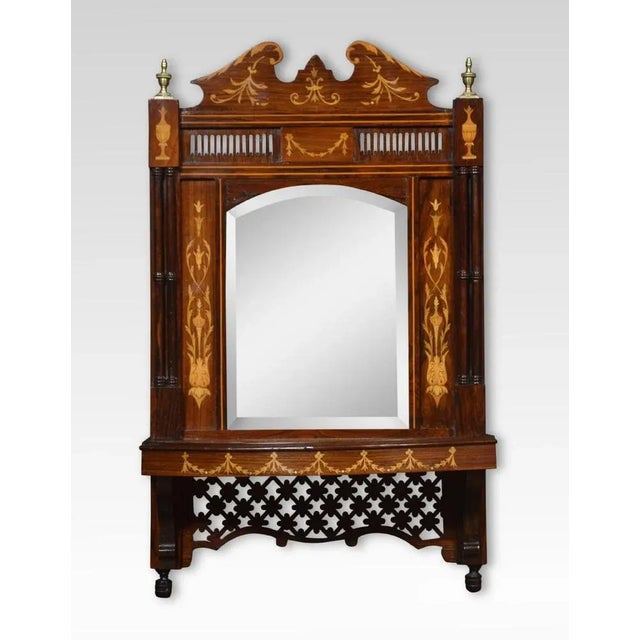 Wall mirror, the molded pediment with scrolling inlaid detail,flanked by brass urn capitals and similar inlaid urns bellow...