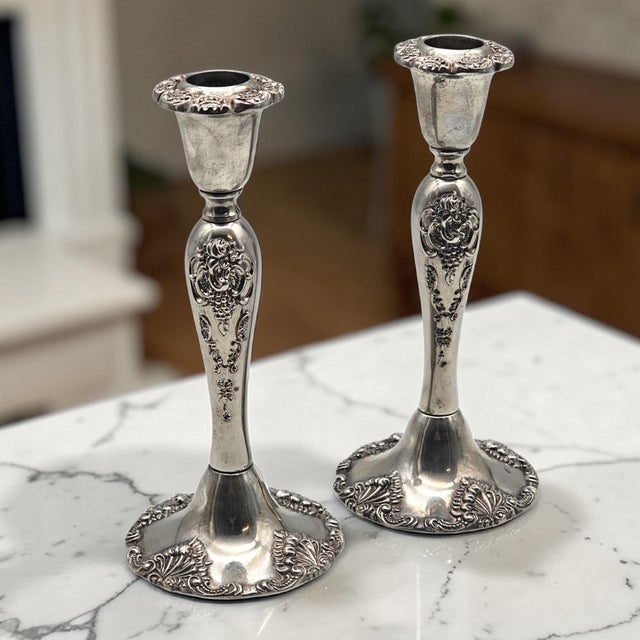 Immediately impactful in both scale and ornament, this pair of Godinger silverplate candlesticks embodies the dramatic...