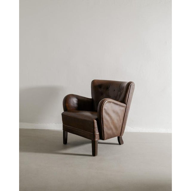 Rare danish mid century armchair model "1669" in beautiful brown patinated leather and dark stained oak feet by fritz...