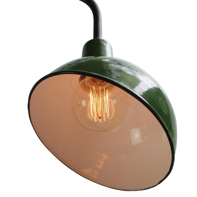 Green enamel industrial wall light with white interior. Diameter cast iron wall mount: 10.5 cm / 4” cm, 2 holes to secure....