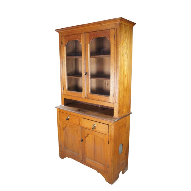 Antique country farmhouse cupboard / cabinet. Made of oak featuring a stepback design with upper glass curio / bookcase...