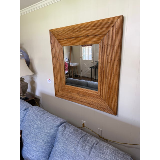 An exceptional vintage split bamboo wall mirror featuring a dramatic wide mitered frame crafted from hundreds of hand-...