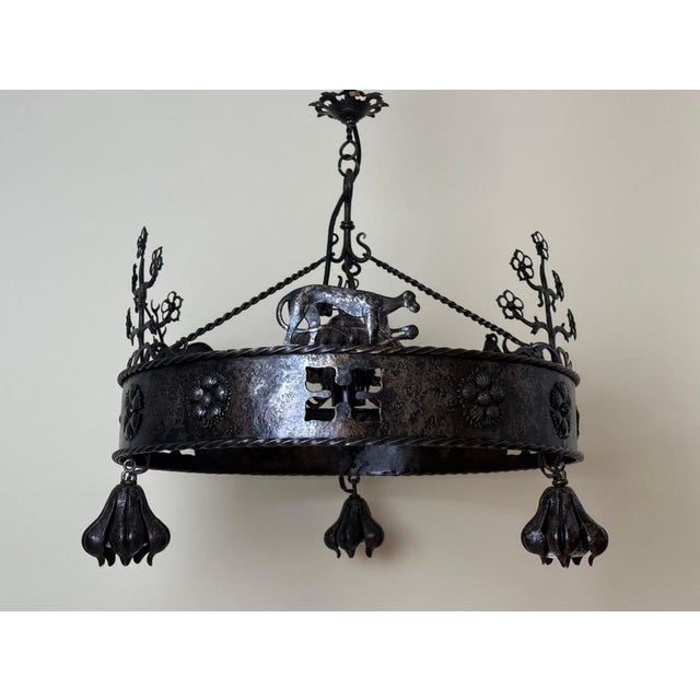 An exceptional hand-forged wrought iron chandelier of remarkable artistic and technical quality, created in the first...