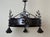 An exceptional hand-forged wrought iron chandelier of remarkable artistic and technical quality, created in the first...