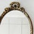 Mid-century oval Baroque mirror with leaf decoration in Hollywood Regency style from the 1960s. This French oval gold...