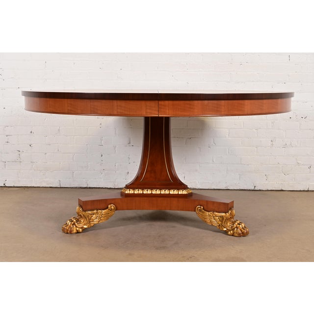 An exceptional Empire, Regency, or Neoclassical style pedestal extension dining table By Baker Furniture USA, Circa 1980s...
