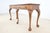Elegant Chippendale-style console table featuring richly figured burled wood drawer fronts, a banded cherry top, and...