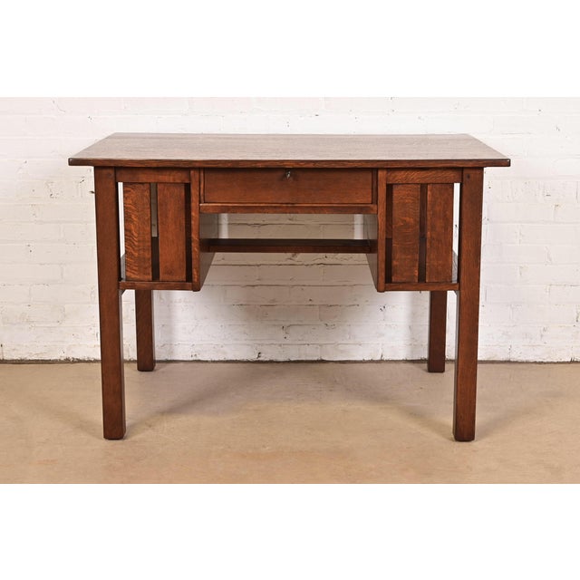 An exceptional antique Mission or Arts & Crafts period quarter sawn oak writing desk or library table By L. & J.G....