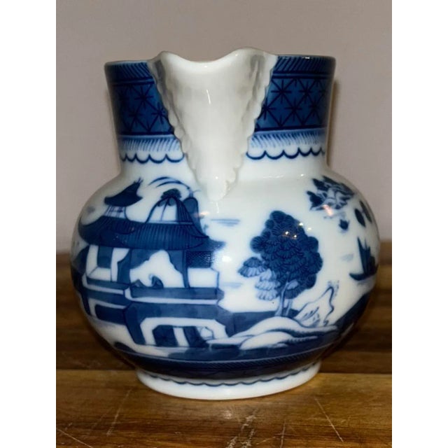 This small pitcher by Vista Allegra, the best porcelain in Portugal, is decorated with a blue and white glazed pattern...