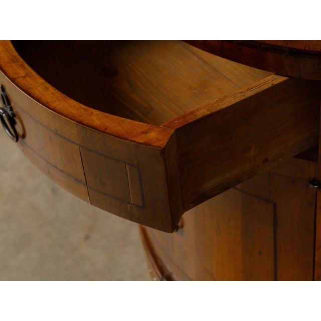 An Italian Neoclassical style walnut demi-lune table from the 19th century with single drawer and door, thin banding,...