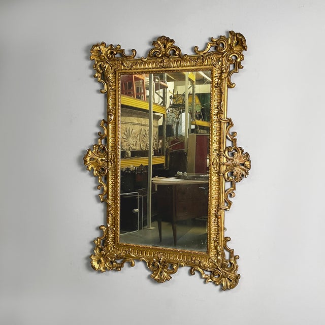 Italian Umbertine style wall mirror with gold wood, 1930s Rectangular wall mirror with a finely crafted frame featuring...