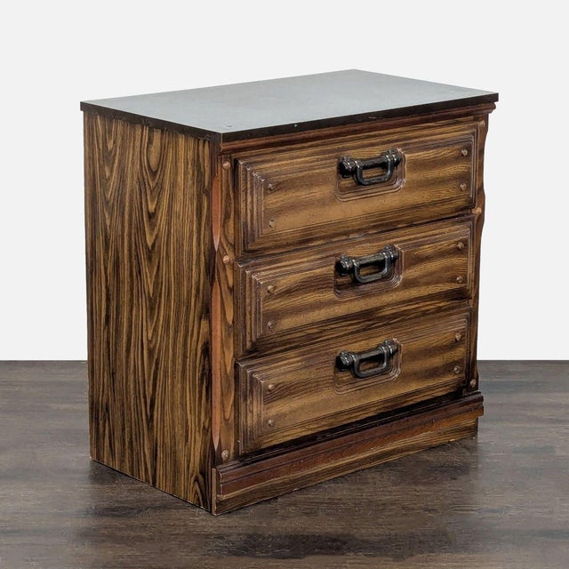 This sturdy wooden dresser features three spacious drawers, perfect for organizing clothes or accessories. The dresser...
