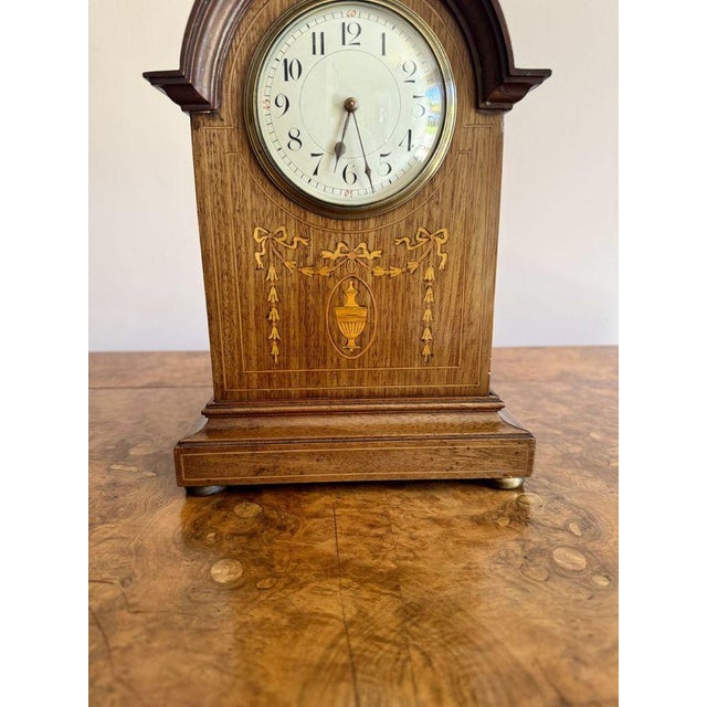 Antique Edwardian quality mahogany inlaid mantle clock having a quality mahogany inlaid case with a shaped top above a...