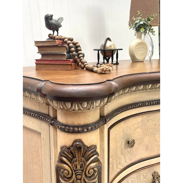 Beautifully refinished six-drawer dresser with warm ash burl detailing, a rich wood top, and ornate brass hardware. Soft...