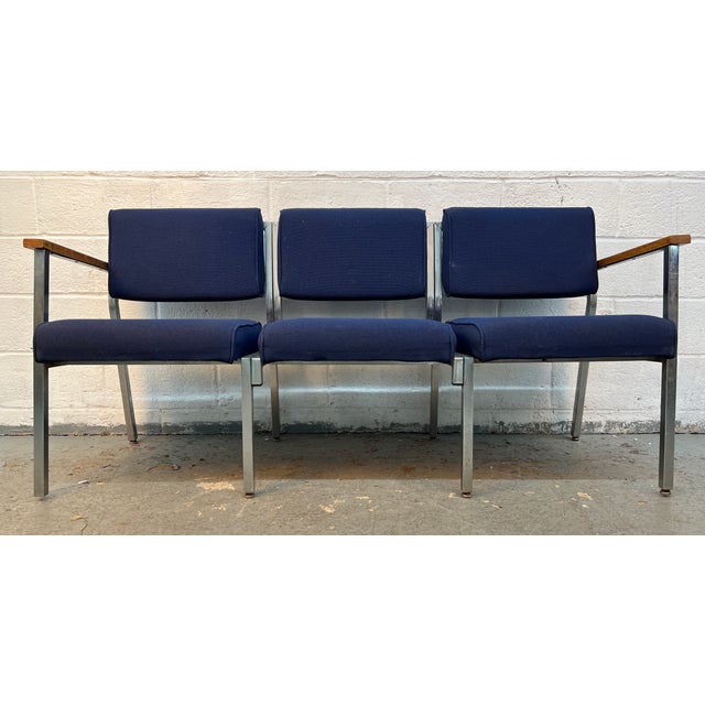 This is a vintage three-seat bench featuring blue fabric upholstery on a chrome frame with wooden armrests. Please confirm...