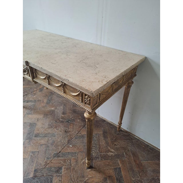 Hutton-Clarke Antiques is pleased to offer this elegant Louis XVI style gilt console, surmounted by a beautifully figured...