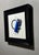 Contemporary Cerium by Patrick Nevins | Oil on Board Blue lighter on a white background with text. For Sale - Image 3 of 3