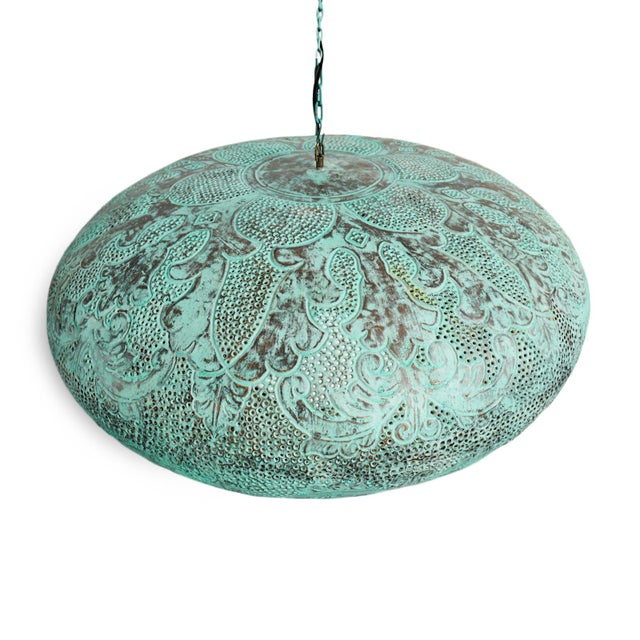 A sculptural statement in hand-worked copper, this Indonesian pendant is distinguished by its richly variegated verdigris...