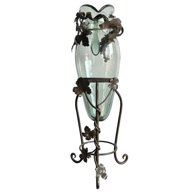 This stunning vintage pitcher jug combines handblown artisan glass with rustic wrought iron craftsmanship, creating a...