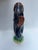 A single antique majolica pottery fish shaped gurgle jug or pitcher with tail handle with multicolor glazed decoration.