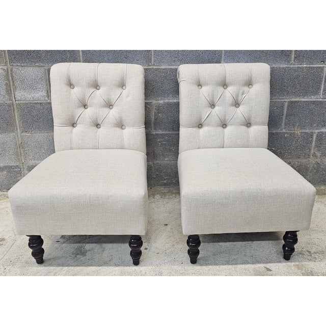 A Pair of Early 21th Century Upholstered and Tufted Slipper Chairs. Measures 22" in width, 27" in depth and 32.5" in...