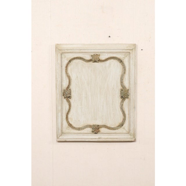 A French carved and painted decorative hanging wall plaque from the early 20th century. This antique wall decoration from...