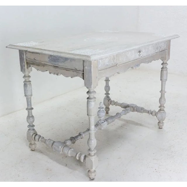 This oak writing table in the Louis XIII style was made in France in the 19th century. The height between the floor and...