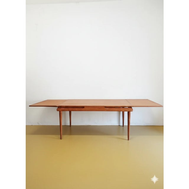 A vintage Danish teak extendable table from the 1960s with an elegant rectangular extension system, perfect for a...