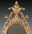 An exceptional quality mid C18th oval giltwood wall mirror, with elaborate overhanging scroll acanthus crest, above...
