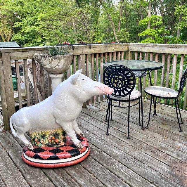 A truly remarkable oversized, hand-built vintage majolica figure of a wild boar atop a round, harlequin-patterned base...
