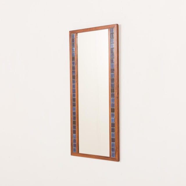 Striking Scandinavian mid-century XL mirror produced in the 1970s, combining a warm rosewood frame with decorative ceramic...