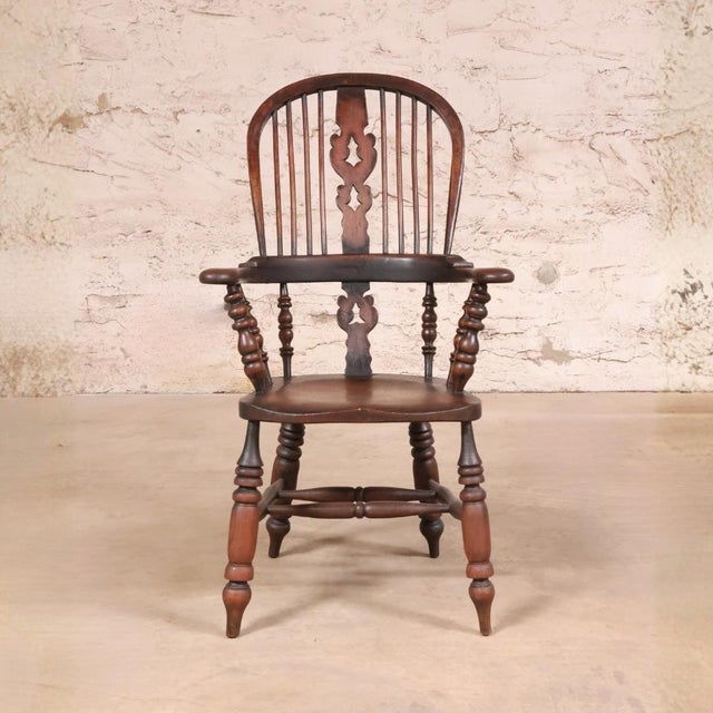 This 18th Century English Walnut Windsor Chair is a beautifully preserved antique that reflects the timeless craftsmanship...