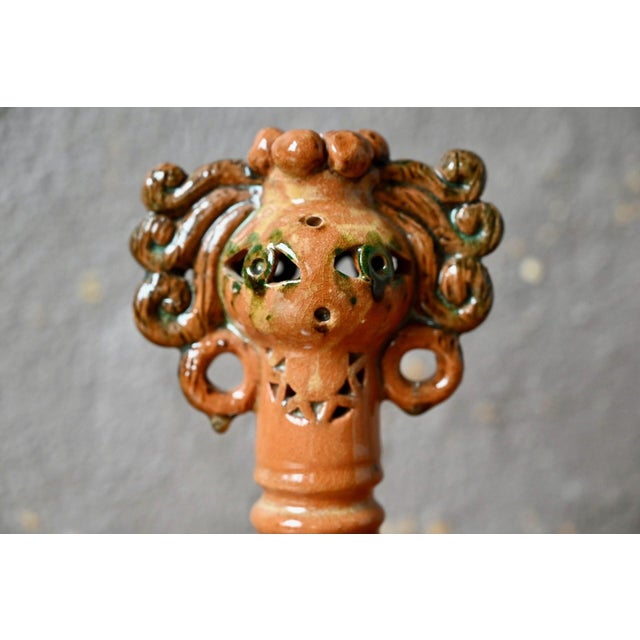 Let yourself be captivated by the magnetic presence of this anthropomorphic sculpture in glazed terracotta, a true...