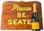 A welcoming “Please Be Seated” sign painted on a substantial solid wood panel. Cream lettering outlined in olive green...