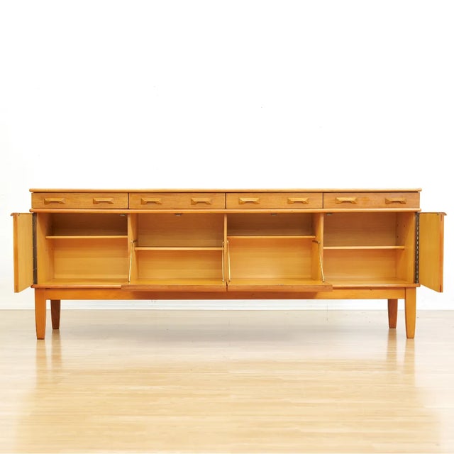 Mid-century credenza designed and manufactured in England during the 1960s. A handsome example, this striking credenza...