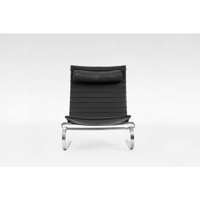 PK20 lounge chair designed by Poul Kjærholm and manufactured by Fritz Hansen. Featuring a black leather seat and stainless...