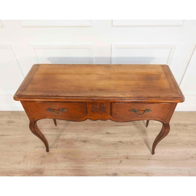 A finely made Provençal console table in solid walnut, crafted in the Louis XV style during the 20th century. The piece is...