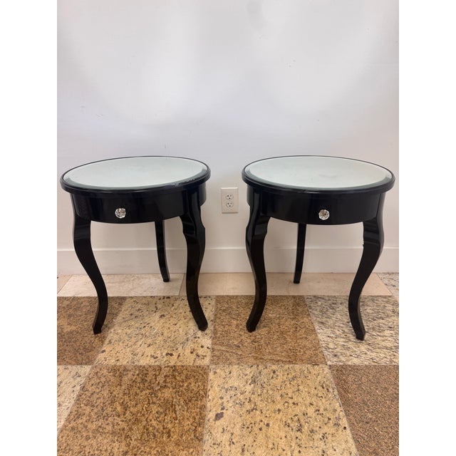 Pair of glamorous black lacquer round side tables from an oceanfront penthouse in Boca Raton. Each table has a round...