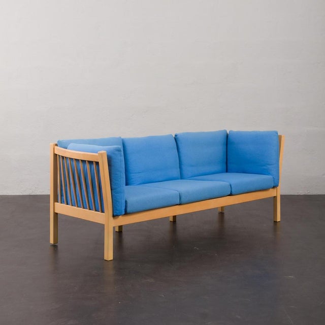This Danish mid-century model of 3 seater sofa is made of blue fabric and a solid beech elaborated frame often seen in...