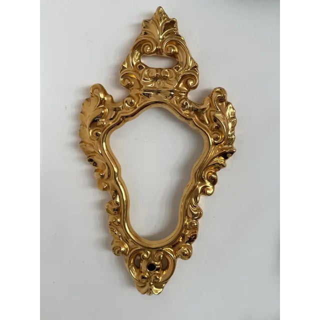 Italian wall mirror frame in molded ceramic with brilliant gilt-lustre overglaze, attributed to a Capodimonte workshop. A...