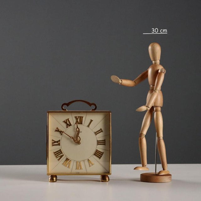 Brass table clock, 8 days, 15 jewels, mechanical movement. Roman numeral hours. This piece is attributed to the mentioned...