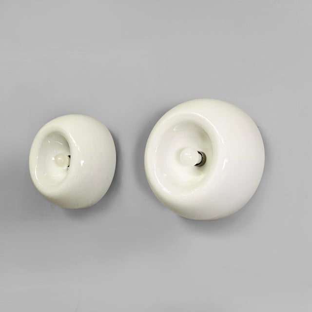 Italian modern opaline glass wall lamps Velella by Achille and Pier Giacomo Castiglioni for Flos, 1970s Pair of wall lamps...
