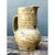 This stoneware jug embraces a classic, functional silhouette, its rounded, full-bellied body rising through a defined...
