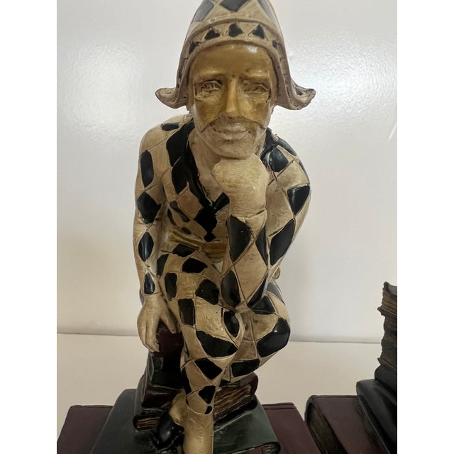 Classical 1920’s French Book Ends figures depicting Harlequin or Jester Figures posing in the classic “Thinker” position...