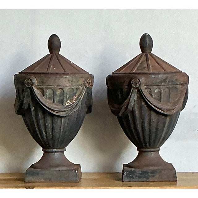 Add architectural gravitas and timeless elegance to your landscape with this substantial pair of vintage cast iron lidded...