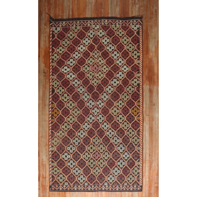 Mid-20th Century Tribal Turkish Jajim kilim in dark colors Measures: 5'4” x 10'2” With the Jijim weaving technique,...