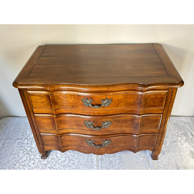 1980’s John Widdicomb French Provincial 3 Drawer Nightstand or small dresser. Possibly Cherrywood with cast brass hardware.